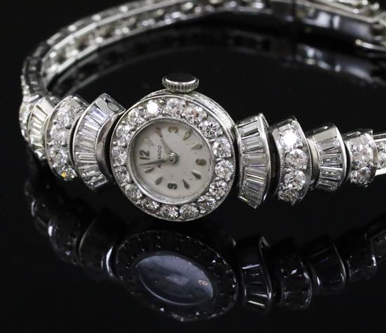 A ladys 1960s Art Deco style platinum and diamond set Movado manual wind cocktail watch, 16.5cm.